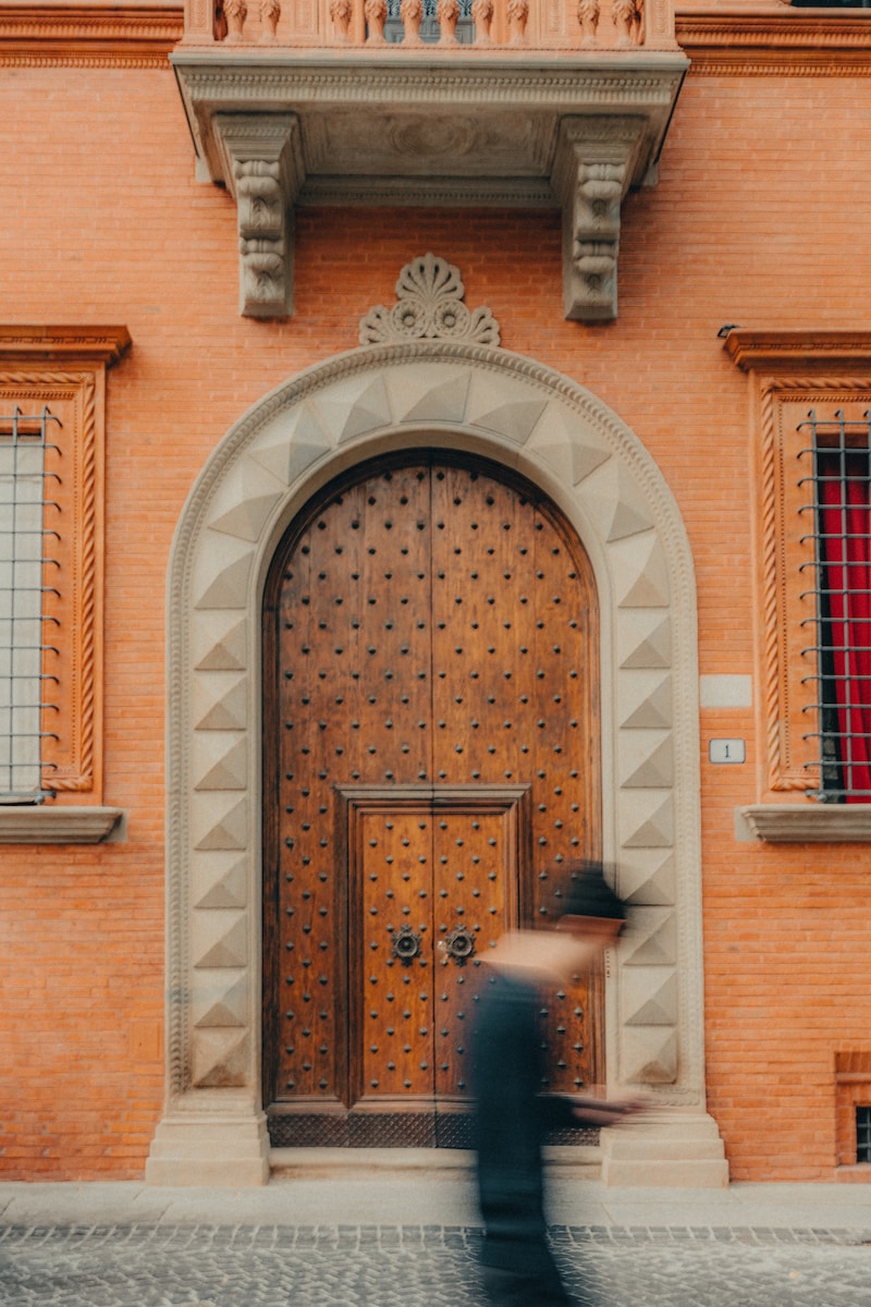 a blurry photo of a person walking in front of a building